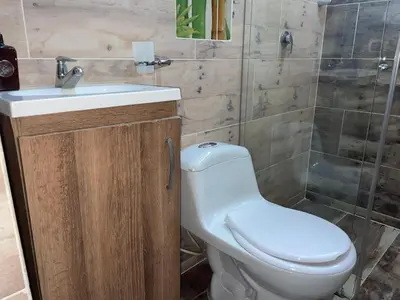 a bathroom with a toilet and a sink and a shower at Loft Belén cerca a Unicentro y Unidad Deportiva Belén Sofá cama in Medellín