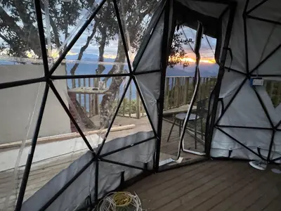 a inside of a tent with a view of a deck at Glamping in Titiribi in Titiribí