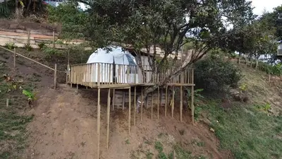 a tree house with a tent on top of a hill at Glamping in Titiribi in Titiribí