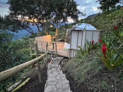 a walkway leading to a yurt on a hill at Glamping in Titiribi in Titiribí