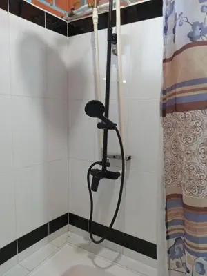 a shower with a black shower head in a bathroom at Bed and bath at Villacarolina in Titiribí