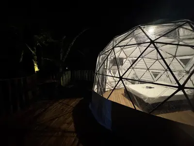 a large glass dome on a wooden table at night at Bed and bath at Villacarolina in Titiribí