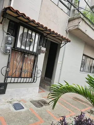 a building with a door and a balcony with a window at Cozy, Convenient and Affordable Loft In Laureles in Medellín