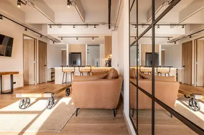 a large living room with chairs and a table at Central, Modern Apartment in Envigado in Envigado