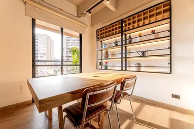 a dining room with a wooden table and chairs at Central, Modern Apartment in Envigado in Envigado
