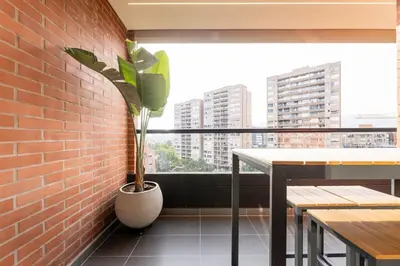 a plant in a pot next to a brick wall at Central, Modern Apartment in Envigado in Envigado