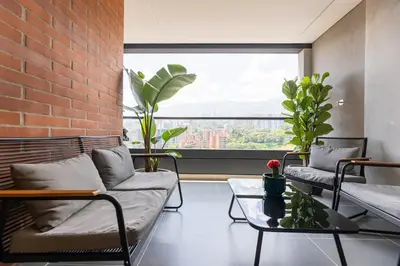 a living room with two couches and a brick wall at Spacious 2H Modern in Envigado in Envigado
