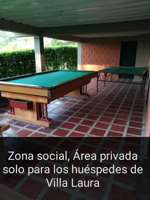 a pool table sitting on top of a patio at El descanso perfecto in Palestina