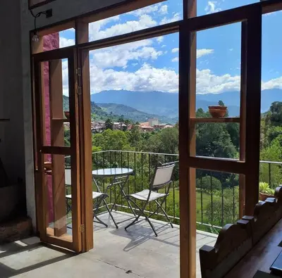 a view from the balcony of a house with a table and chairs at Jardín Utopía in Jardin