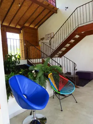 a room with two chairs and a staircase at Jardín Utopía in Jardin