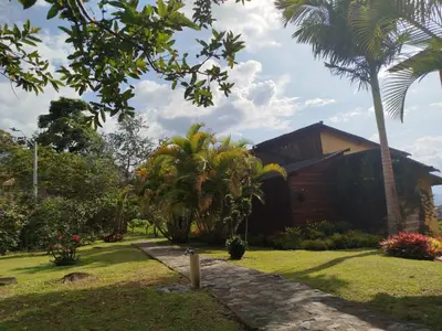 a house with palm trees in front of it at Jardín Utopía in Jardin