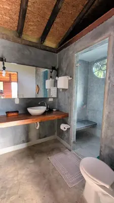 a bathroom with a sink and a toilet and a mirror at Jardín Utopía in Jardin