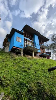 a blue house on top of a hill at Jardín Utopía in Jardin