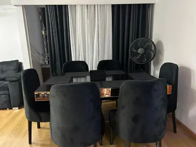 a dining room with a black table and chairs at Luxurious Stay 2 in Bello