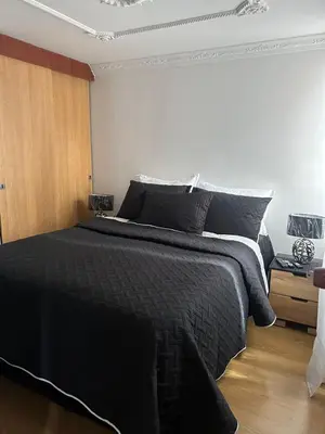 a bedroom with a large bed with black sheets at Luxurious Stay 2 in Bello