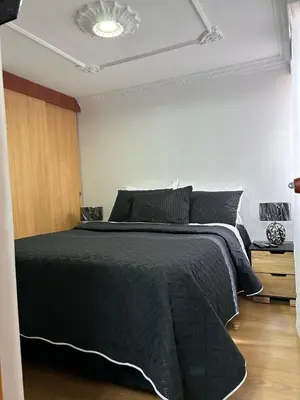 a bedroom with a bed with a black comforter at Luxurious Stay 2 in Bello