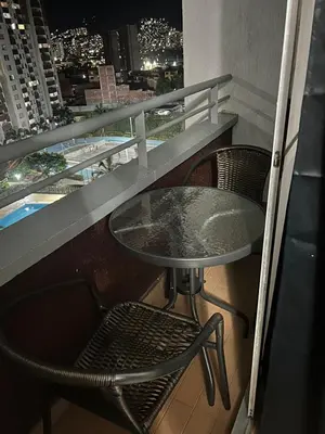 a table and chairs on a balcony with a view of a city at Luxurious Stay 2 in Bello