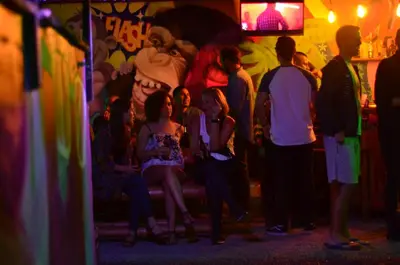 a group of people sitting in a dark room at Purple Monkey Hostel in Medellín