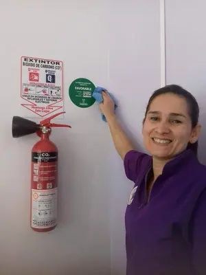 a woman is painting a wall with a fire extinguisher at Purple Monkey Hostel in Medellín