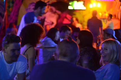a group of people in a crowd at a party at Purple Monkey Hostel in Medellín