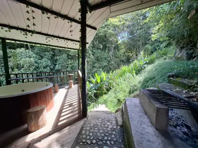 a bathroom with a tub on a wooden deck at Casa de lujo wifi jacuzzi charcos parking in Barbosa