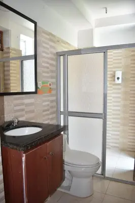 a bathroom with a toilet and a sink and a shower at hotel bocas del cauca in Tarso