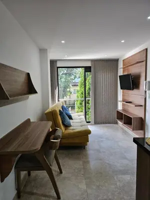 a living room with a couch and a table at Medellín te Espera Modern & Central Apartment for Travelers in Medellín