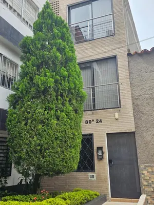a large tree in front of a building at Medellín te Espera Modern & Central Apartment for Travelers in Medellín
