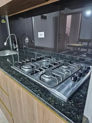 a stove top oven sitting on top of a kitchen counter at Medellín te Espera Modern & Central Apartment for Travelers in Medellín