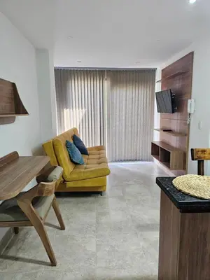 a living room with a yellow couch and a television at Medellín te Espera Modern & Central Apartment for Travelers in Medellín