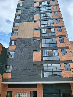 a tall building with windows on the side of it at A home away from home! in Medellín