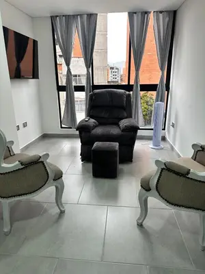 a living room with a couch and a chair at A home away from home! in Medellín