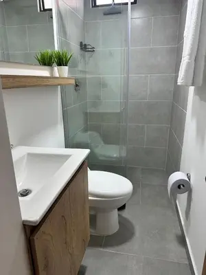 a bathroom with a toilet and a sink and a shower at A home away from home! in Medellín