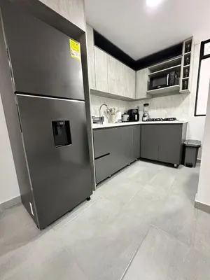 a kitchen with a stainless steel refrigerator in a room at A home away from home! in Medellín