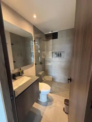 a bathroom with a toilet and a sink and a shower at Apto Bonito Poblado in Medellín