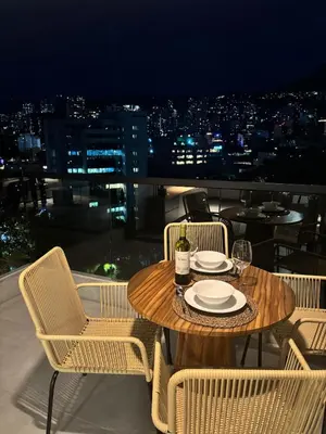 a table and chairs on a balcony with a view at Apto Bonito Poblado in Medellín