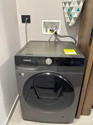 a washing machine is sitting in a room at Apto Bonito Poblado in Medellín