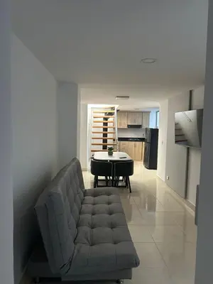 a living room with a couch and a table at precioso apto para su estadia in Medellín