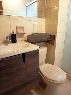 a bathroom with a toilet and a sink at Céntrico Apartamento Belén in Medellín
