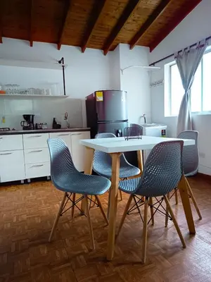 a kitchen with a table and four chairs at Céntrico Apartamento Belén in Medellín