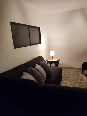 a living room with a black couch and a table at Casa Manila Medellin in Medellín