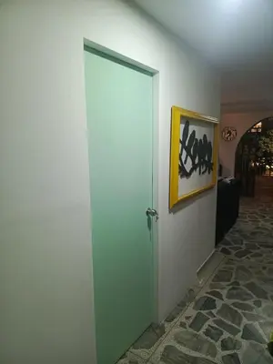an open door in a room with a picture on the wall at Casa Manila Medellin in Medellín