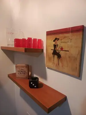 a shelf on a wall with a picture of a woman at Casa Manila Medellin in Medellín