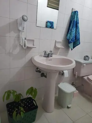a bathroom with a sink and a toilet at Casa Manila Medellin in Medellín