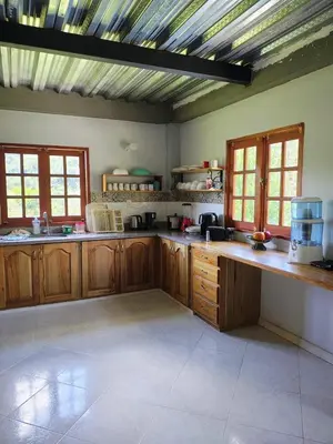 a large kitchen with wooden cabinets and a ceiling at Cabaña en San Rafael Cerca de Ríos y Naturaleza in San Rafael
