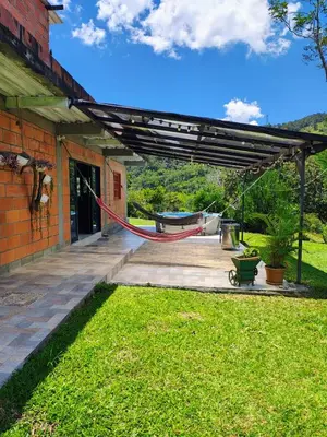 a patio with a hammock under a pergola at Cabaña en San Rafael Cerca de Ríos y Naturaleza in San Rafael