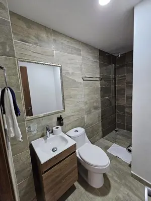 a bathroom with a toilet and a sink and a shower at Modern Luxury Laureles Life in Medellín