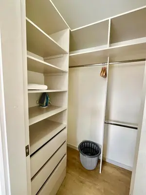 a walk in closet with white shelves at El Poblado, Balcony, Pool, Jacuzzi, Gym, Steamroom in Medellín