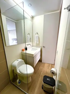 a bathroom with a toilet and a sink and a mirror at El Poblado, Balcony, Pool, Jacuzzi, Gym, Steamroom in Medellín