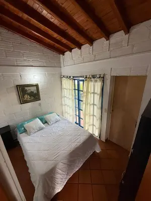 a bedroom with a white bed in a room at Finca Marinilla in Marinilla